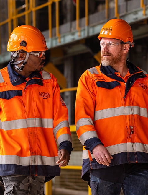 Two operators walking around a manufacturing site